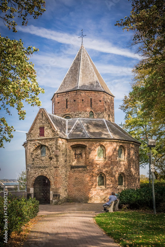 medieval building, Sint Nicolaaskapel, in Nijmegen, the Netherlands surrounded by trees in a park. photo