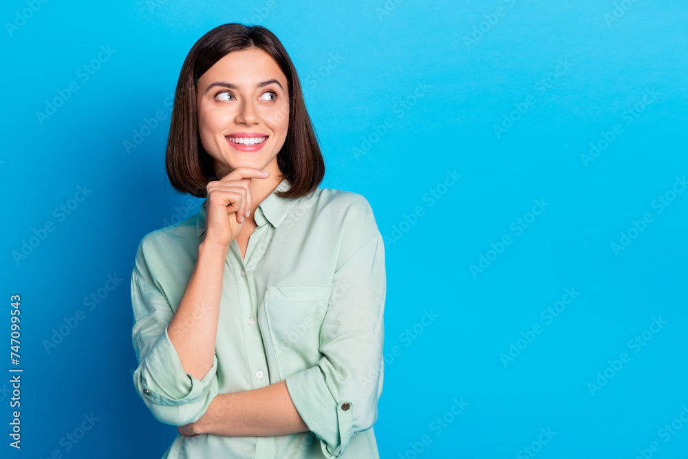 Photo of clever positive woman with bob hairstyle dressed teal shirt look at proposition empty space isolated on blue color background Photo of clever positive woman with bob hairstyle dressed teal shirt look at proposition empty space isolated on blue color background