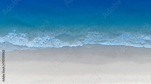 The soft wave water of the sea on the sandy beach background © SASITHORN
