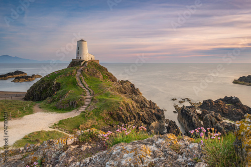 The majestic Twr Mawr lighthouse at sunset on the island of Ynys Llanddwyn in Anglesey, North Wales.