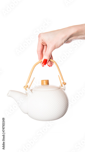 Ceramic teapot in female hand isolated on white background. White teapot.