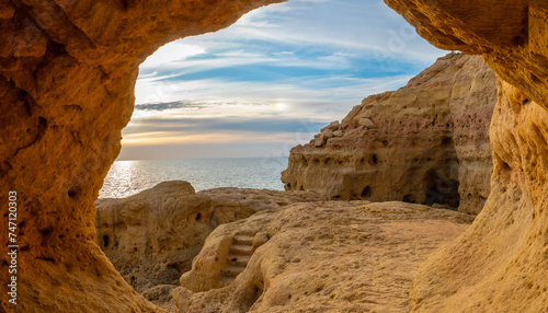Natural caves with a stunning view of a sunset over the Atlantic ocean, Algar seco cliffs, Carvoeiro, Lagoa, Algarve, Portugal.