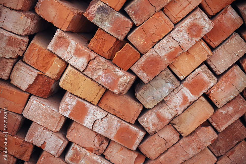 Stack of bricks masonry close up. Process of house building and building materials concept. Red bricks for laying at construction site. Brick wallpaper pattern Stack of bricks masonry close up. Process of house building and building materials concept. Red bricks for laying at construction site. Brick wallpaper pattern