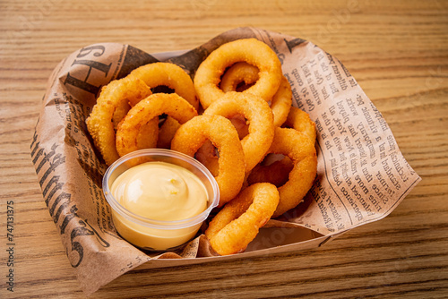 onion ring with sauce on wooden background