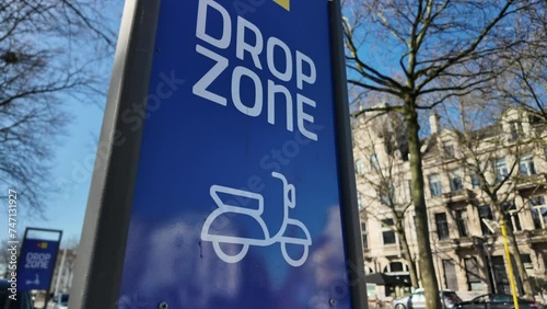 Sharing bike drop zone sign in city, sharing economy, scooter