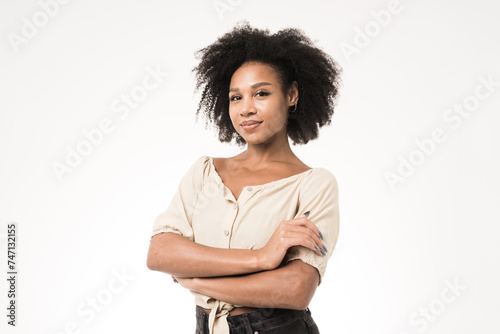 Slika na platnu Confident woman with arms crossed on a white background.