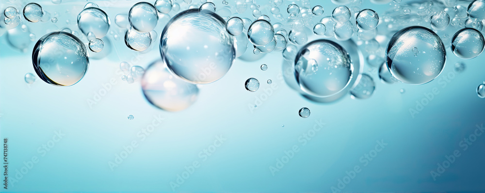 Water bubbles on wide white blue background.