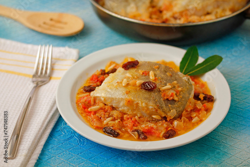 Cod with raisins and pine nuts.