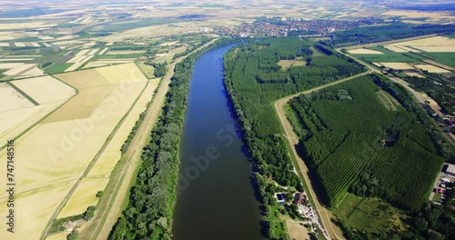 Aerial view of beautiful Tisza river surrounded with green trees in Serbia