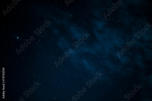 Stars in the night sky through the clouds. Beautiful starry night sky with clouds. © Trik
