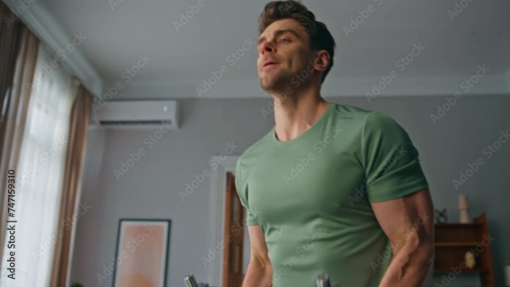 Man pumping hands muscles at home workout close up. Athlete lifting dumbbells Man pumping hands muscles at home workout close up. Athlete lifting dumbbells