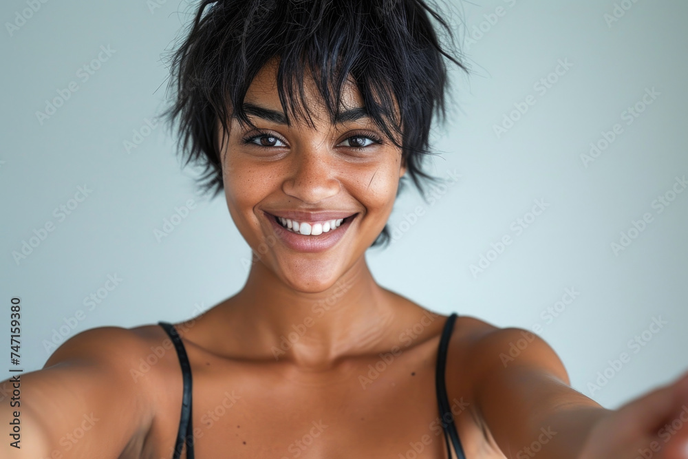 Woman in bra top holding cell phone