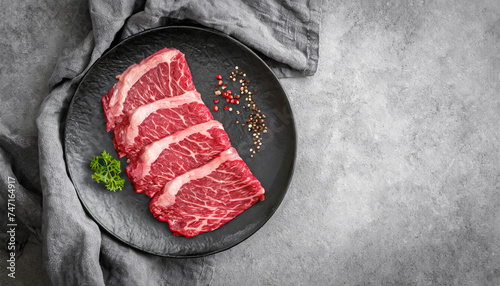 wagyu, Japanese beef. top view of Sliced wagyu marbled beef for yakiniku on black plate, copy space