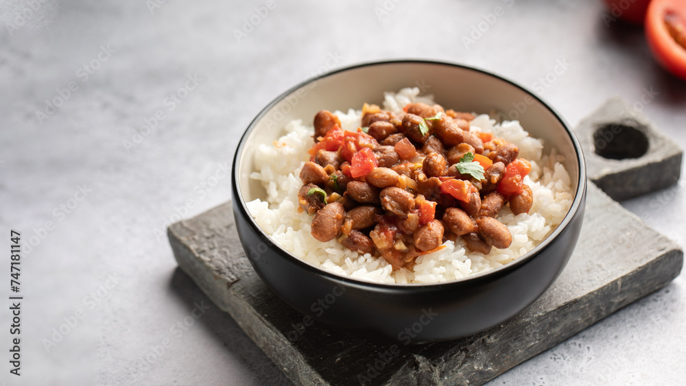 Vegan bean curry with rice and tomatoes. Indian cuisine. Vegetarian dish. Vegan bean curry with rice and tomatoes. Indian cuisine. Vegetarian dish.