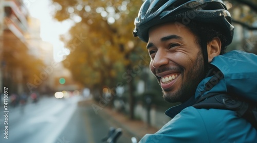 Happy man in helmet riding bicycle on city street. photo