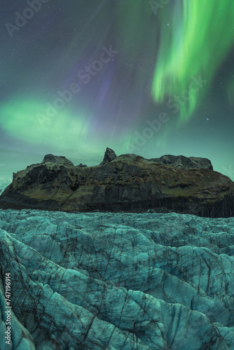 Northern lights dancing over an Icelandic glacier photo