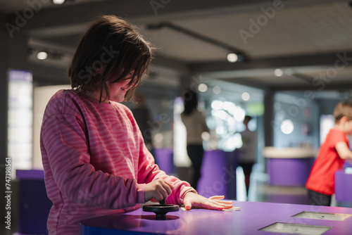 Kids exploring interactive exhibits at a science museum photo