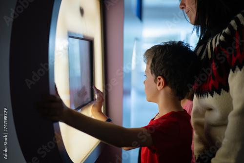 Children exploring interactive exhibit at science museum photo