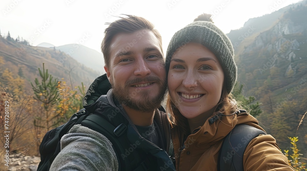 Portrait of young happy couple tourists on a mountain
