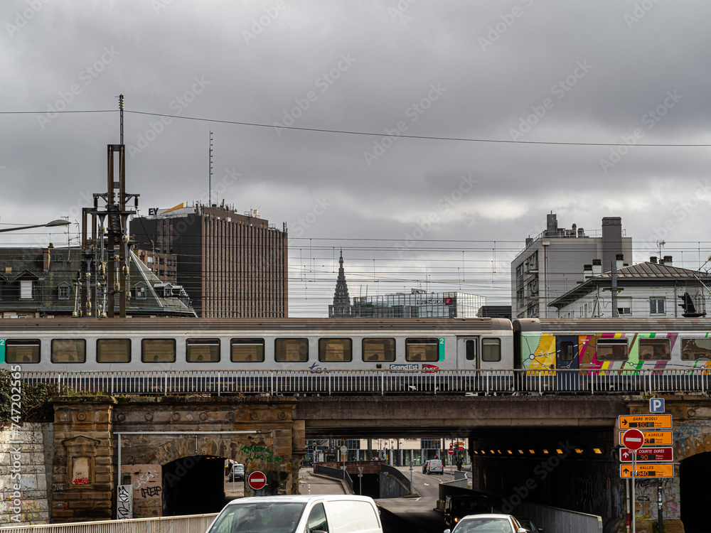 Fototapeta premium Strasbourg in Alsace. Urbanism. Interweaving of wires, trains, buildings, cars, roads.