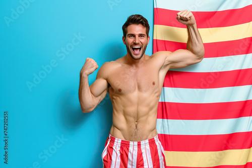 Photo guy fist up scream yes swimmer ocean distance win wear red striped set shorts isolated vivid color background