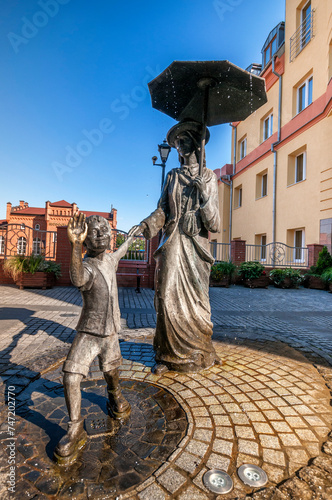 Sculpture of lady with a boy in Grudziadz, city in Kuyavian-Pomeranian Voivodeship, Poland.