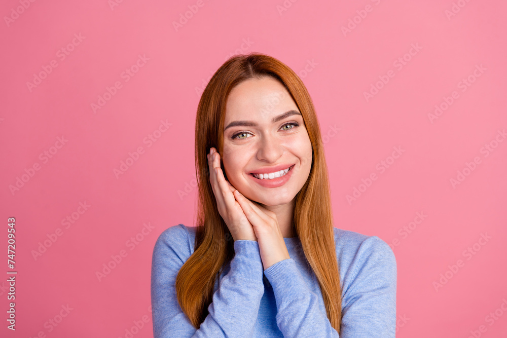 Portrait of sleepy dreamy cheerful girl with foxy hairdo wear blue pullover holding palms on cheeks isolated on pink color background Portrait of sleepy dreamy cheerful girl with foxy hairdo wear blue pullover holding palms on cheeks isolated on pink color background
