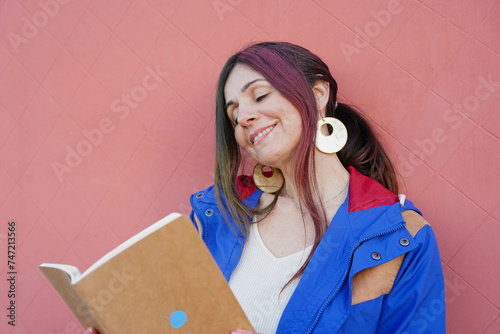 daydreamer smiling woman reading a novel. Imagination concept. world book day photo