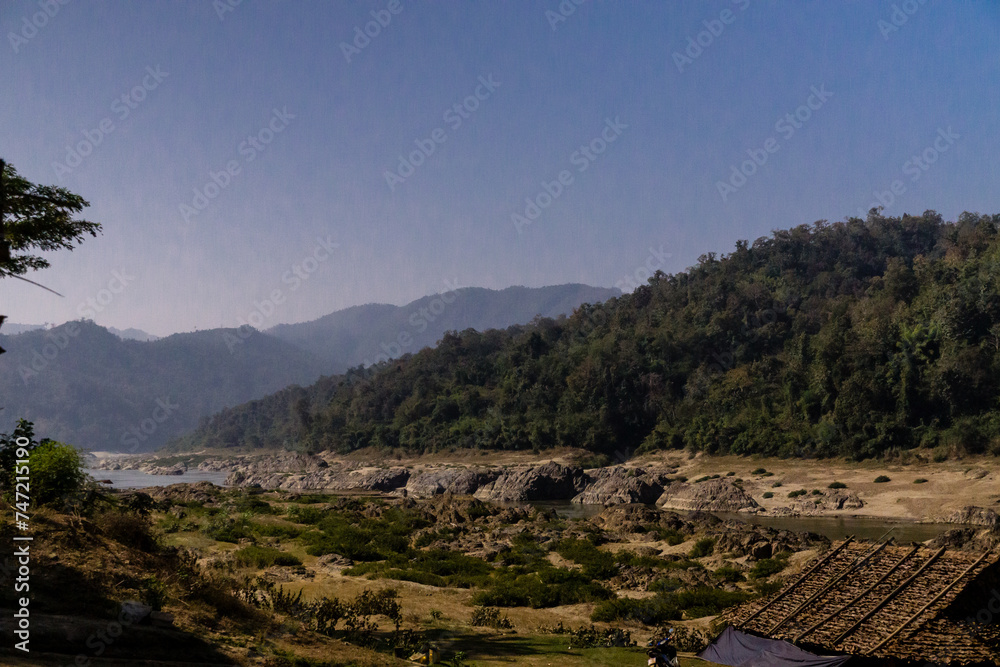 Landscape with mountains, forest and river in the foreground. Landscape with mountains, forest and river in the foreground.