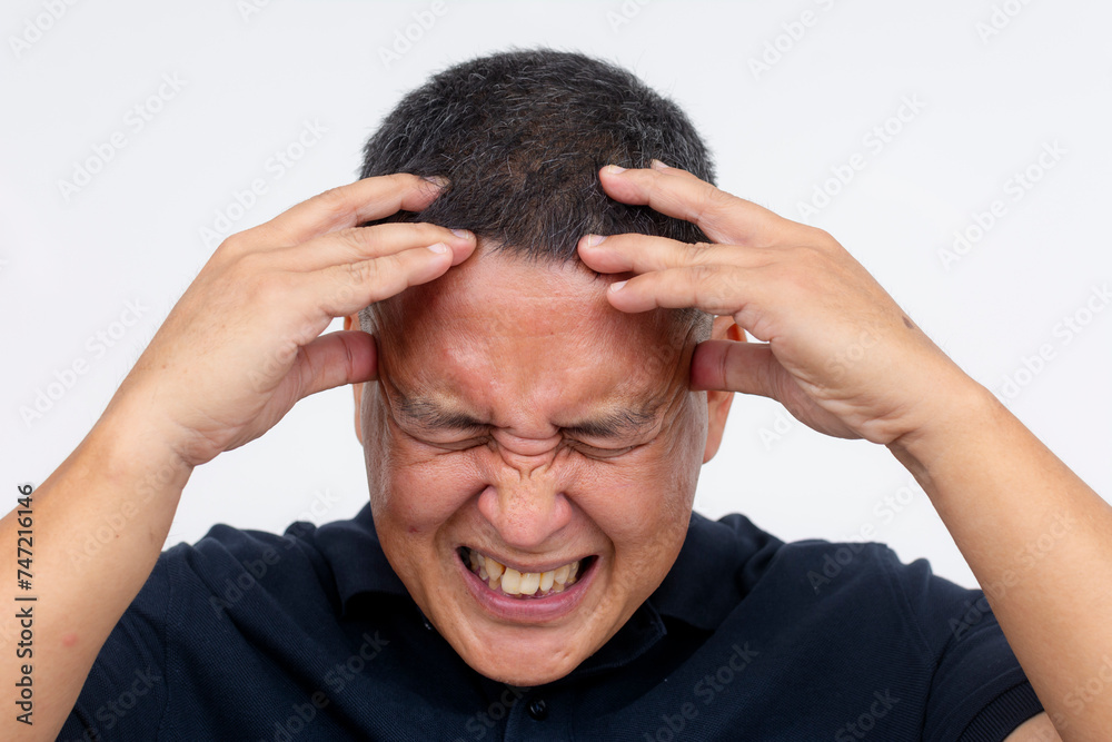Closeup shot of a middle-aged man isolated on white, clutching his head and wincing in pain, depicting a severe headache or migraine. Closeup shot of a middle-aged man isolated on white, clutching his head and wincing in pain, depicting a severe headache or migraine.
