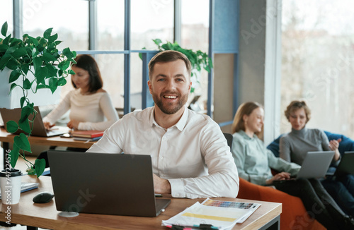 Wallpaper Mural Sitting by laptops. People are working in the office with bean bags chairs in it Torontodigital.ca