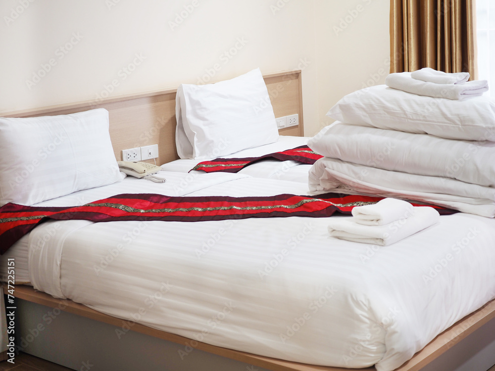 Side view of hotel amenities (such as towels, hankie, etc) on the bed. Side view of hotel amenities (such as towels, hankie, etc) on the bed.