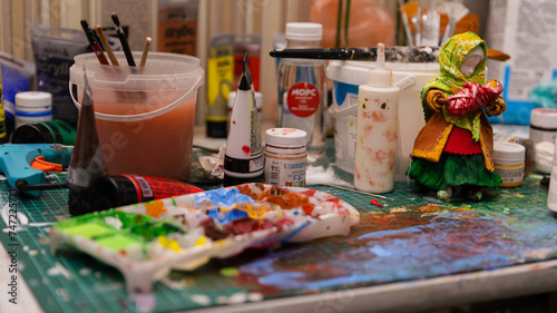 The Artist's Colorful Workspace: A Table Laden with Paints, Creating a Working Atmosphere