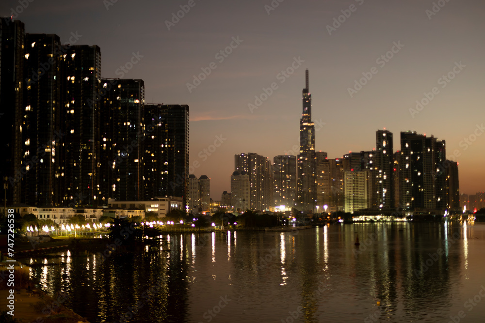 Obraz premium Landmark and Golden river buildings early morning on Saigon River Ho Chi Minh City, Vietnam