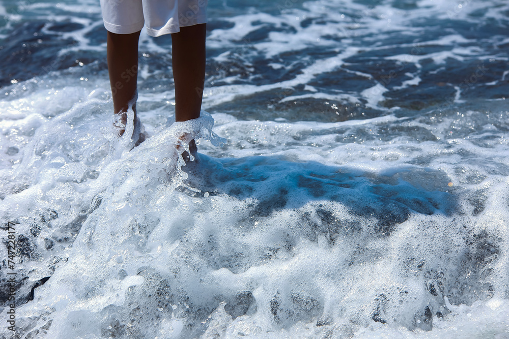 Fototapeta premium Feet in the water by the sea