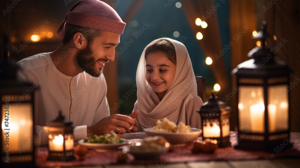 A Muslim family, a Father and Daughter having dinner at home at a festive table in a modern house. Iftar celebration, the Holy month of Ramadan Karim, Culture, Religion, Islam, Holiday concepts. A Muslim family, a Father and Daughter having dinner at home at a festive table in a modern house. Iftar celebration, the Holy month of Ramadan Karim, Culture, Religion, Islam, Holiday concepts.