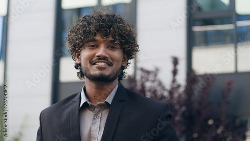 Hispanic Arabian male business man smiling happy businessman in city portrait success urban entrepreneur looking at camera smile in downtown male office worker employer successful entrepreneur outdoor