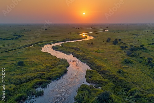 River Flowing Through Lush Green Field
