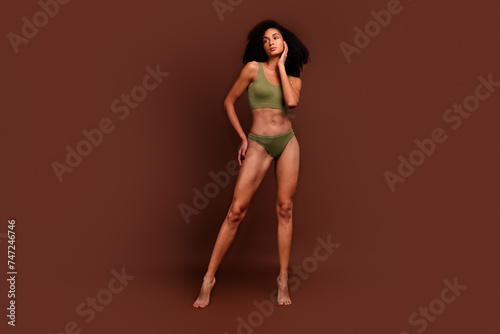 No retouch full length photo of gorgeous sporty girl with strong flawless mascular body empty space isolated on brown color background
