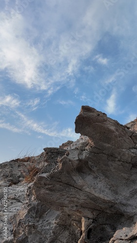 Red rocks and sky landscape with clouds over mountains