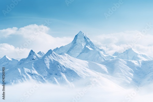 a snowy mountain tops with clouds
