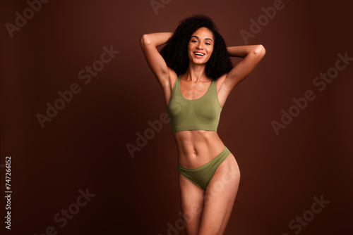 Studio no retouch photo of seductive charming lady dressed lingerie love herself empty space isolated brown color background