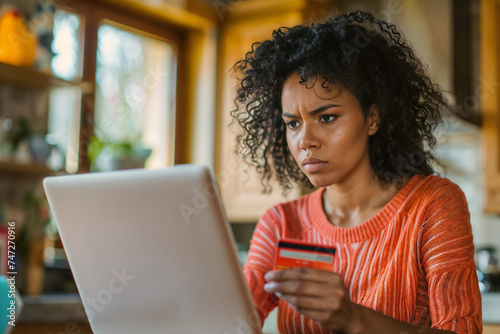 Frustrated woman sitting on laptop photo