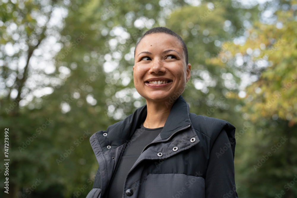 Portrait of smiling woman in sports clothing in park Portrait of smiling woman in sports clothing in park