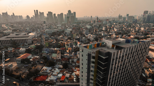 A scenic view of Metro Manila's skyline at dusk, focusing on the dense urban landscape with Makati buildings.