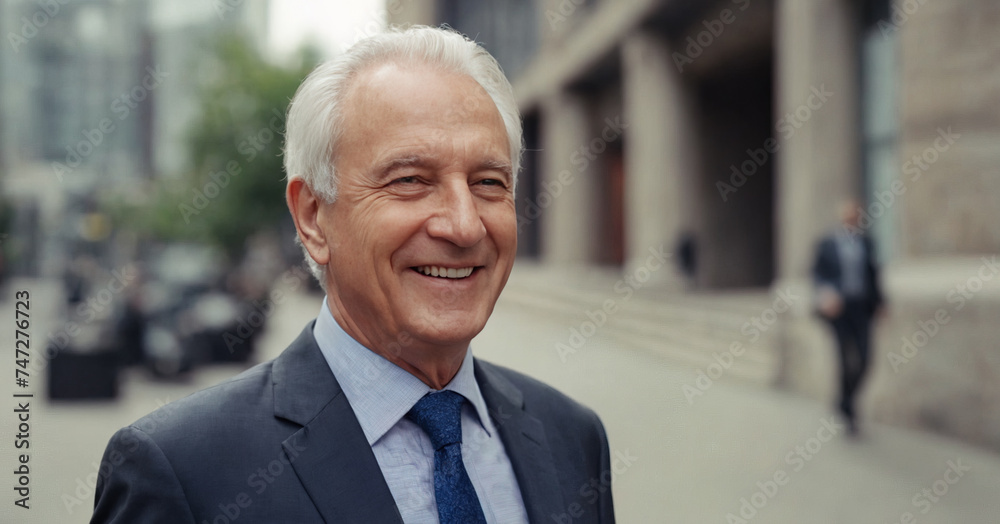 A confident older businessman in a professional suit, wearing a pleasant smile, embodies success and experience in a corporate portrait. A confident older businessman in a professional suit, wearing a pleasant smile, embodies success and experience in a corporate portrait.