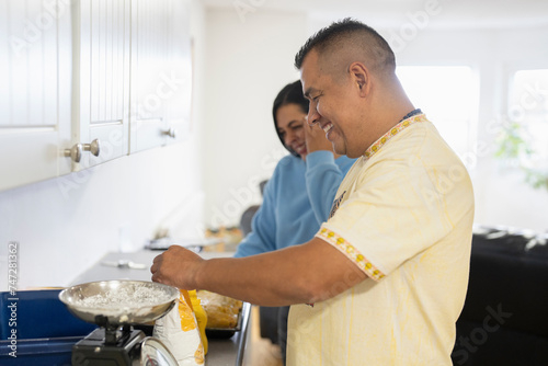 Members of family preparing food in kitchen