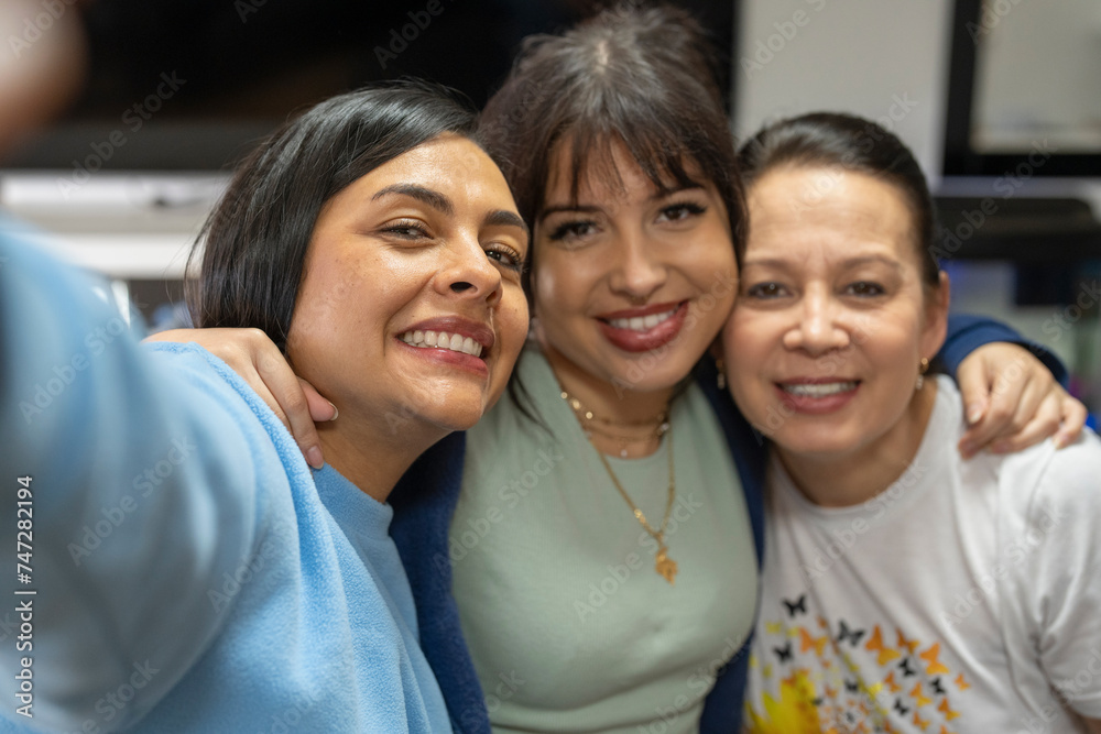 Portrait of three women embracing Portrait of three women embracing