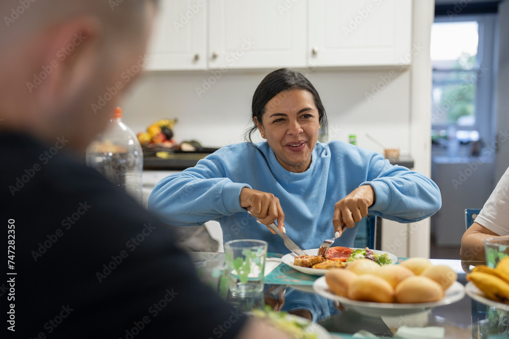 Family sitting at dining table and enjoying lunch
