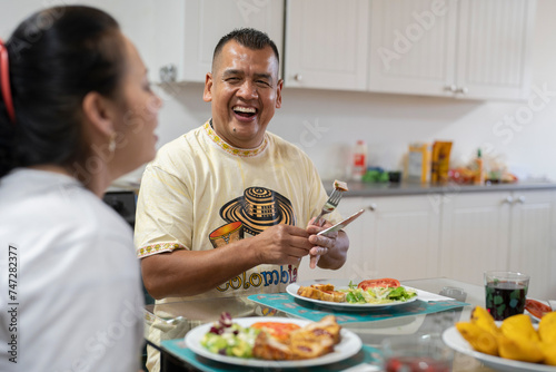 Family sitting at dining table and enjoying lunch